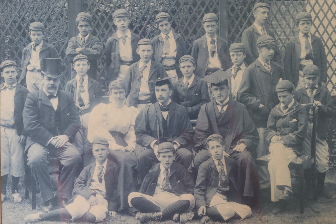 Photo from 1896 shows J.S Lewis third from right on the back row.  Pupils are pictured with staff including Headmaster Grenfell