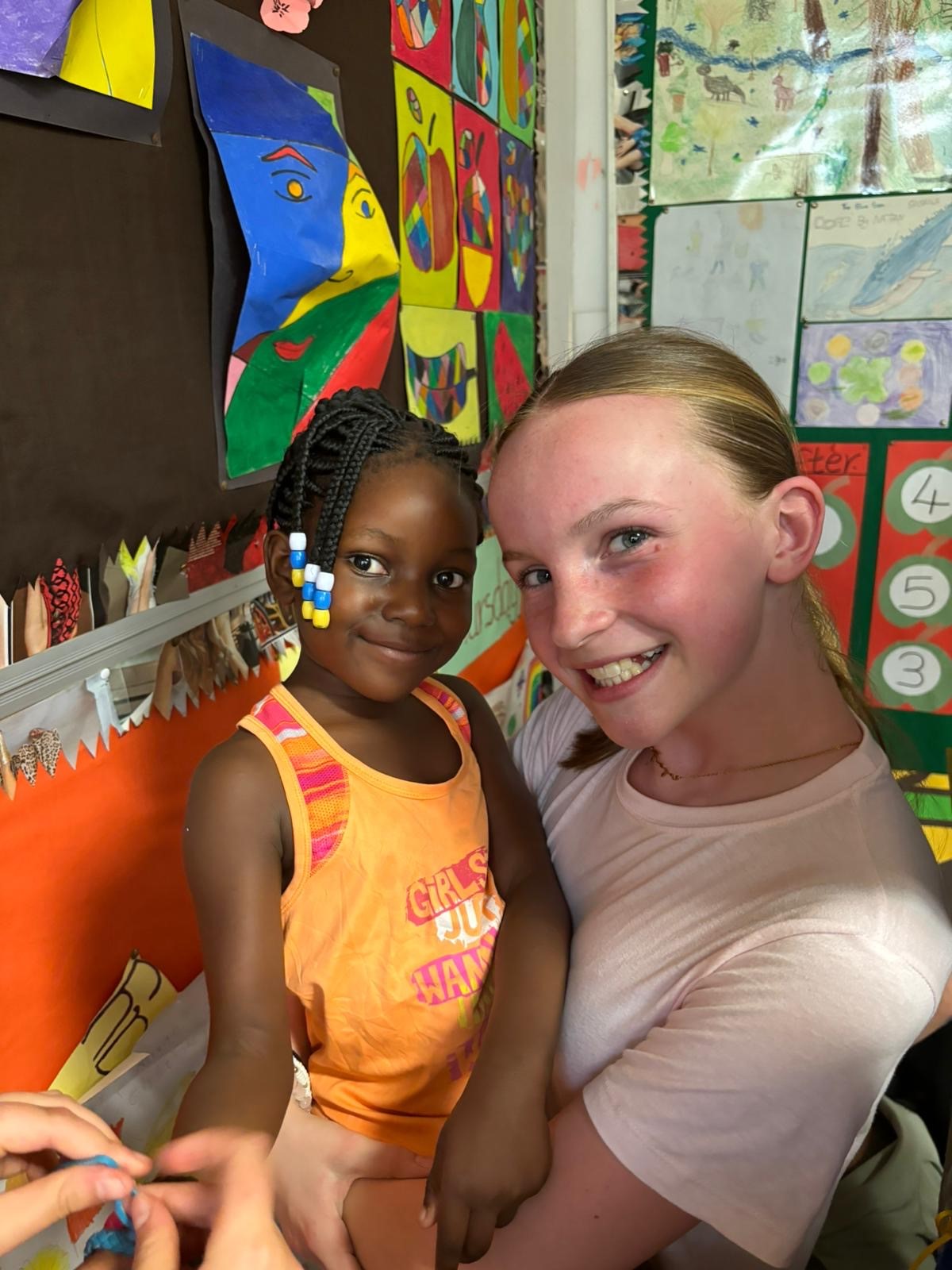 Heath Mount pupil hugs one of the young patients at Twende Education For All learning centre at the hospital in lusaka
