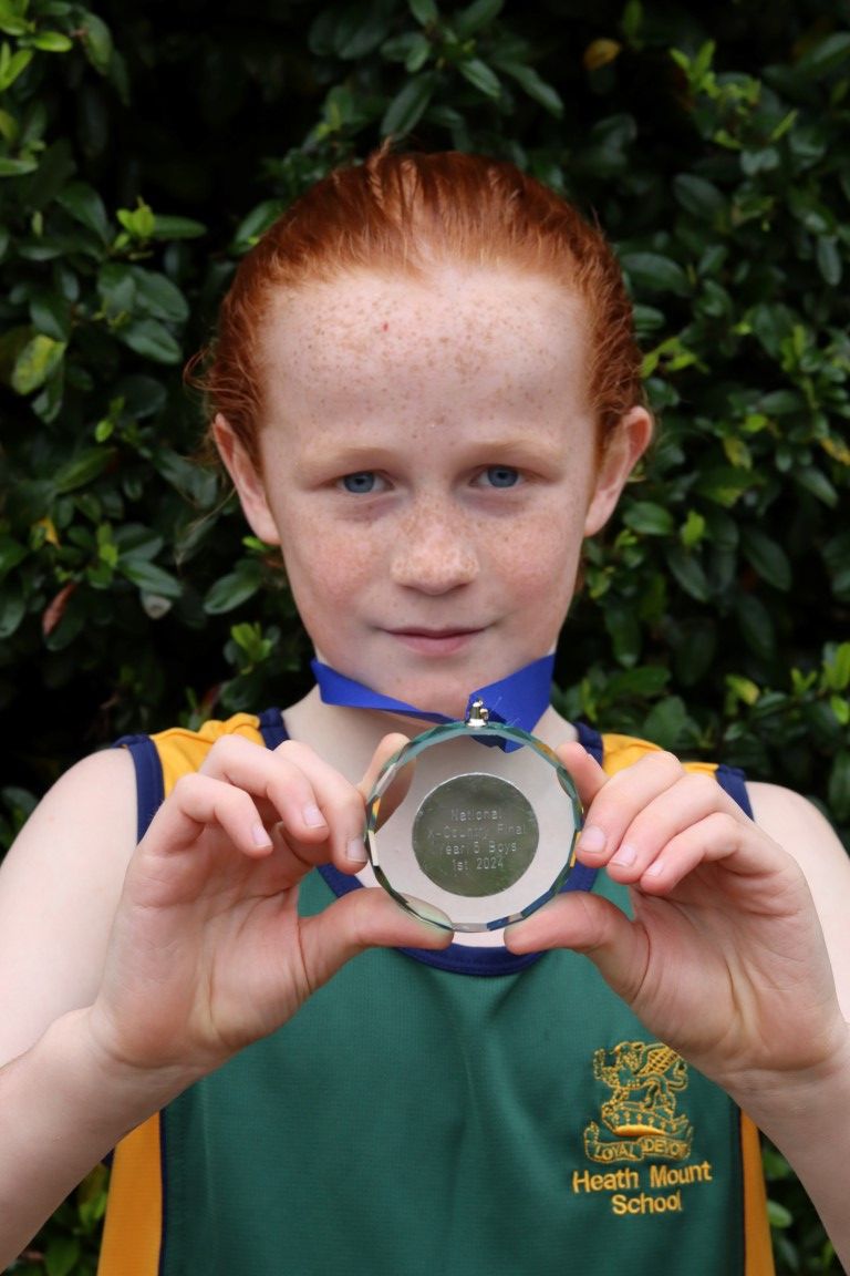 William holds his first place medal for winning the National Primary Schools' Cross Country Championship