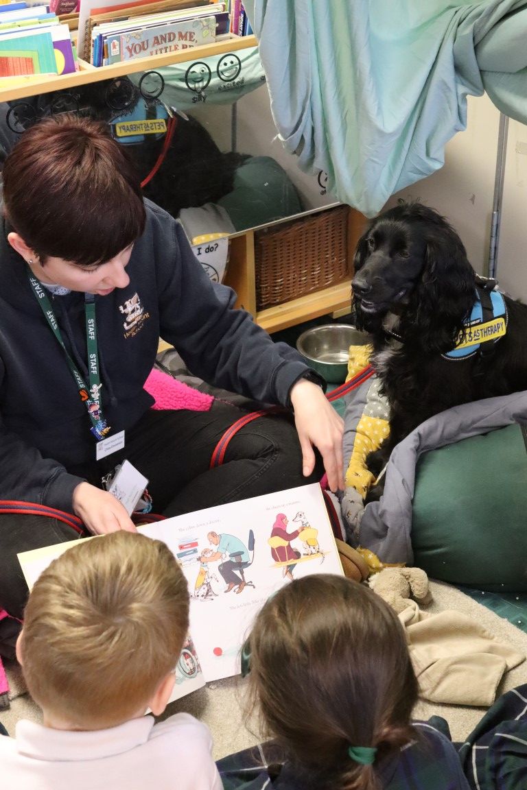 Miss Emmerson reads The Hospital Dog to pupils with Luna, our school nurture dog