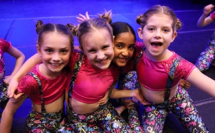 Four girls look happy as they prepare to go on stage for the Heath Mount Dance Show