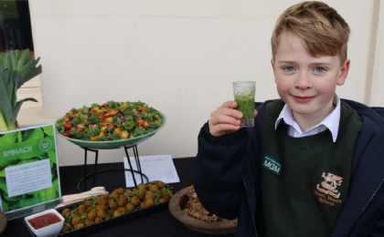 Child drinks spinach smoothie to celebrate nutrition day and healthy eating at Heath Mount