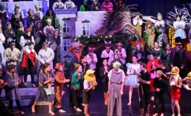 60 children dressed as fairytale characters act out a scene in Shrek The Musical JR in Heath Mount School's state of the art theatre